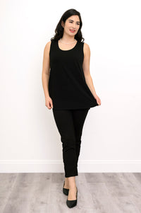 Woman wearing a black sleeveless top and black pants against a white background, front view