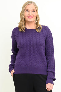 Front view of a female model wearing a purple sweater with black pants, against a white backdrop