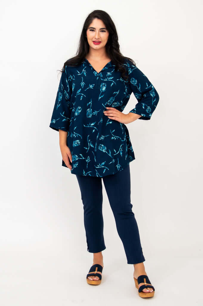 Model showing the Kary Tunic Top with hand on hip, indigo rose print visible