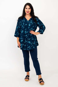 Model showing the Kary Tunic Top with hand on hip, indigo rose print visible
