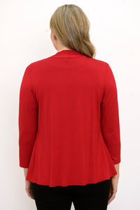 Back view of woman wearing a red cardigan, black top, and black pants on a white background