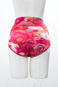 Back view of full-coverage woman's panties featuring a red and pink floral print