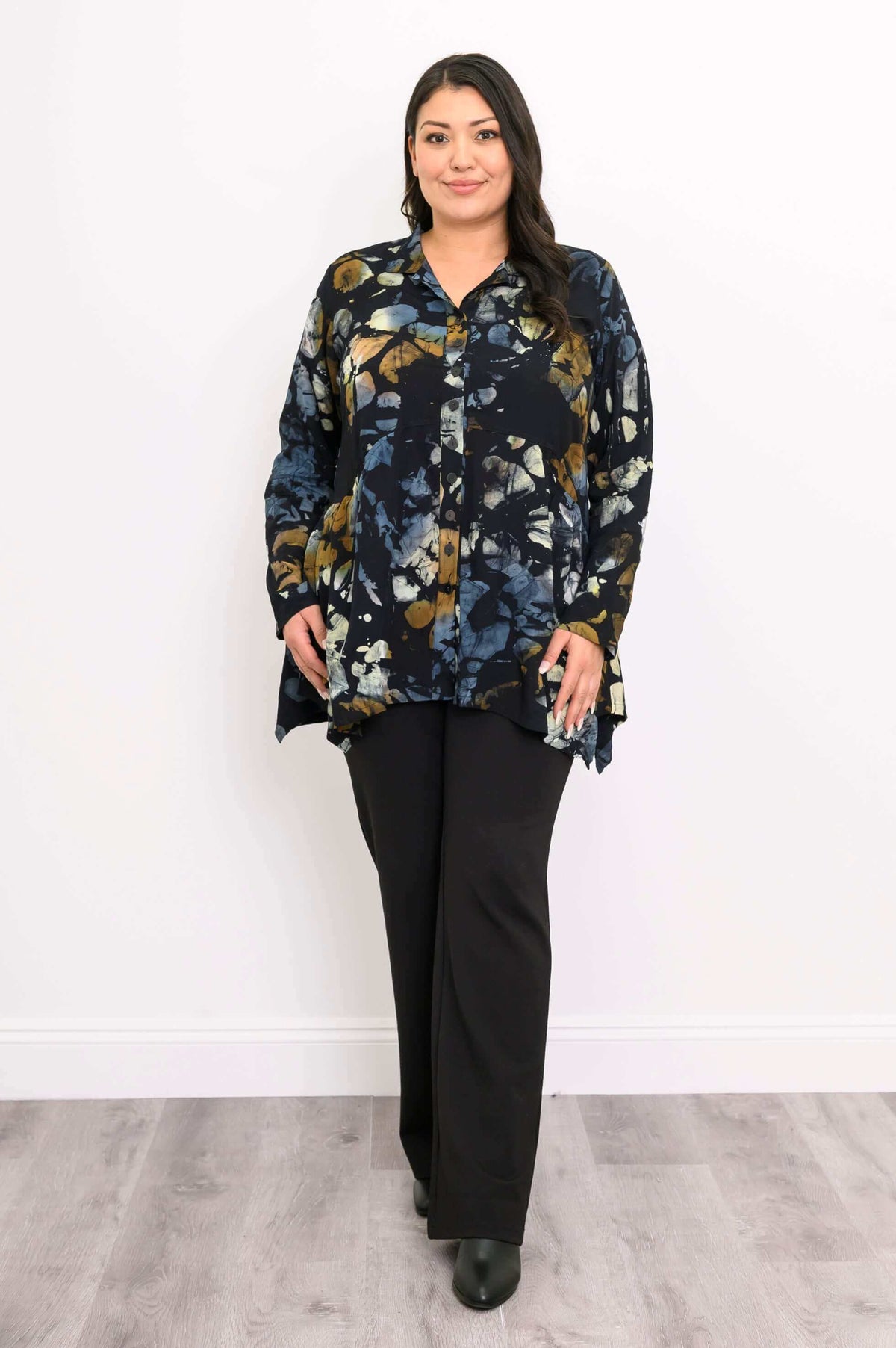 Woman wearing Laney Blouse in Night Bloom, full front view with black pants