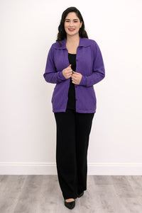 Model posing in a plum cotton cardigan layered over a simple black top, shown front-facing against a plain wall.