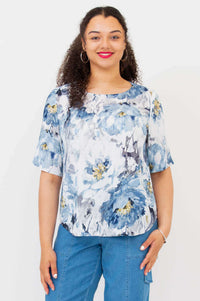 Front view of model wearing Liza floral bamboo-linen blouse with blue watercolor flower print