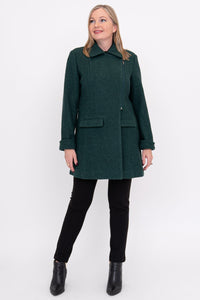 Woman wearing a green coat, black pants, and black shoes on a white background, front view