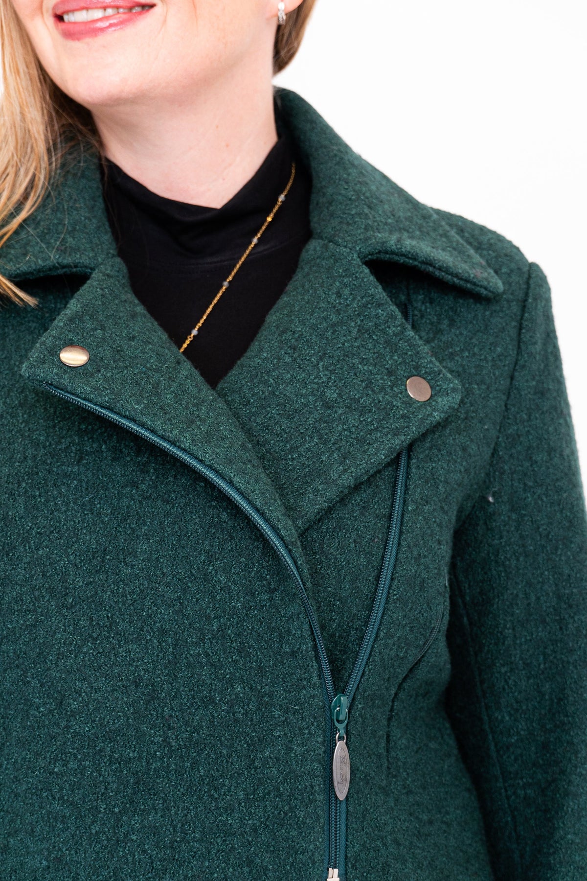 Green coat with a close-up of the collar and buttons on a white background