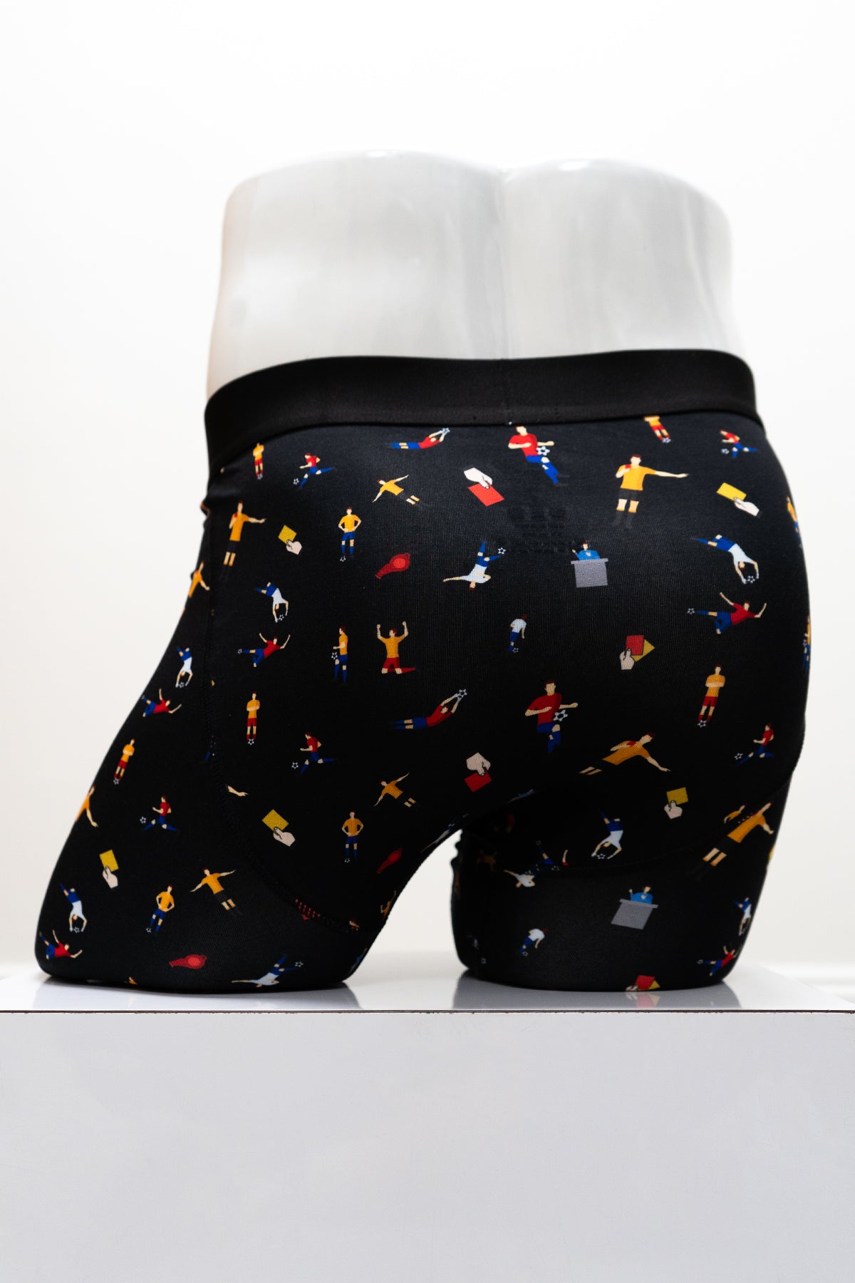 Black boxer briefs with soccer-themed print and 'Blue Sky Guy' waistband on a white mannequin, back view