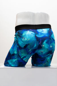 Blue tie-dye boxer briefs with 'Bluesky Guy' waistband on a mannequin against a white background, back view
