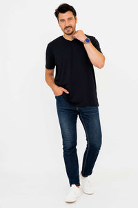 Man in black V-neck t-shirt and jeans, casual walking pose, front view