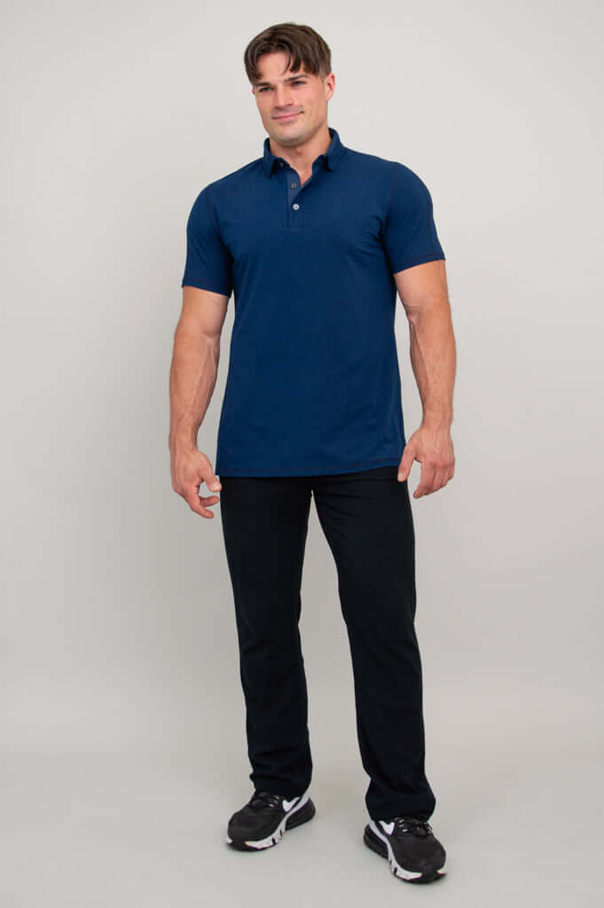 Man in navy blue polo shirt and black pants, full body, facing slightly right