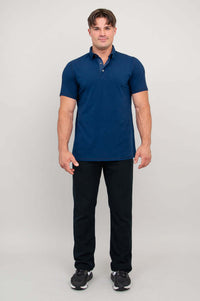 Man in navy bamboo polo shirt, standing straight, arms relaxed, front view