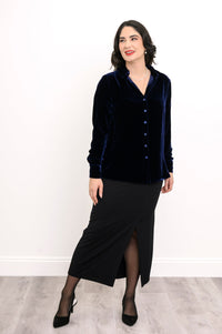 Straight-on full body portrait of a navy blue silk velvet button-down shirt styled with a black maxi skirt