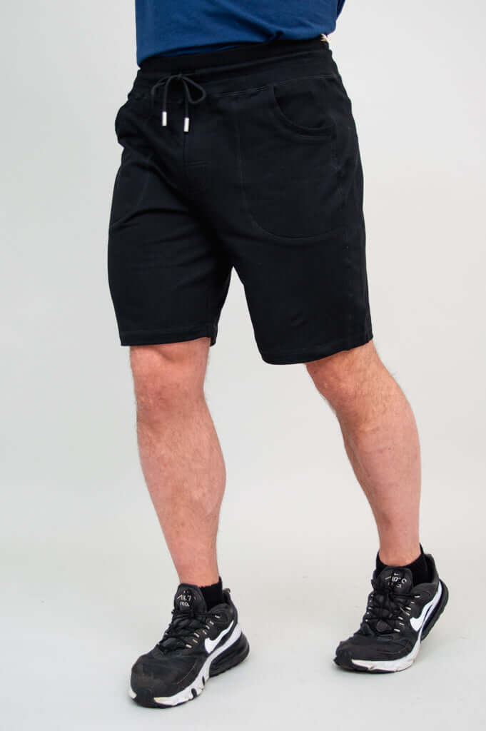 Back view of men's black shorts and legs