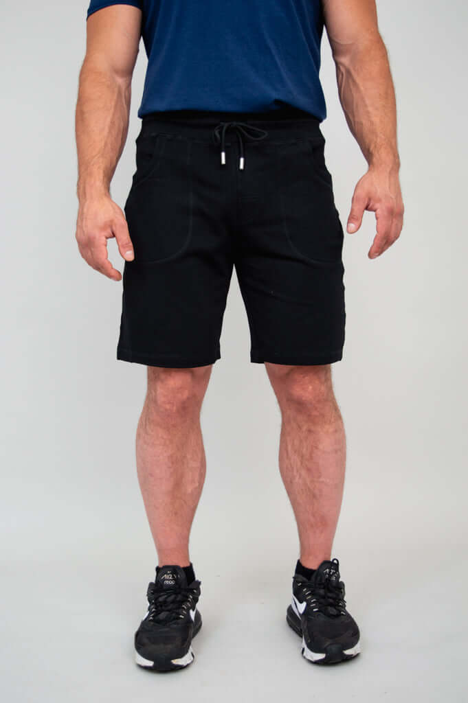 Men's black shorts, front view with hands at sides