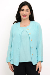 Woman wearing a light blue jacket on a light blue top and black pants on a white background, front view