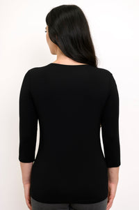Back view of model wearing a black 3/4 sleeve top and grey pants against a white background