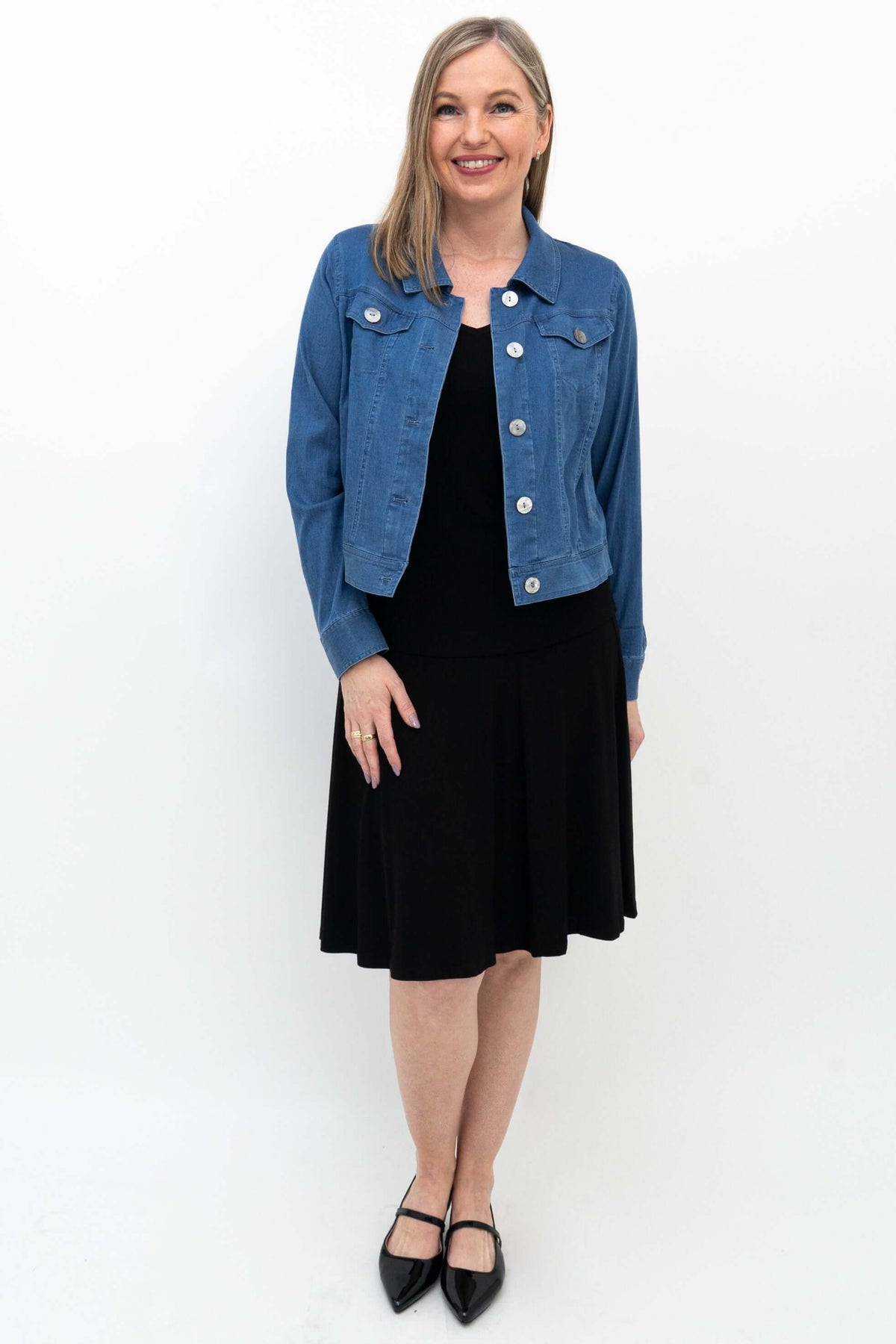 Model in Aly fit and flare black skirt styled with denim jacket