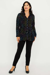 Model smiling and standing in Cindy smocked dot shirt and black pants