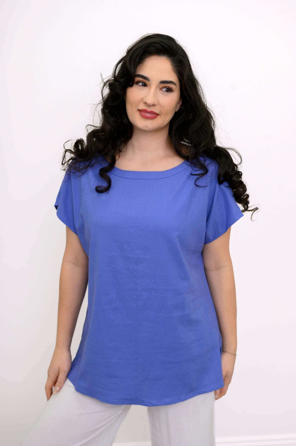 Model facing forward wearing blue Aria Tee with relaxed fit