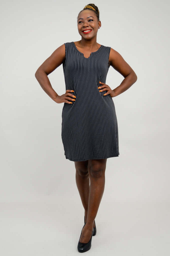 Woman with hands on hips modeling knee-length pinstripe bamboo shift dress