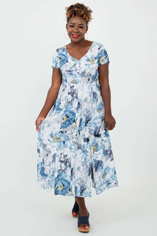 Model displaying the flowy skirt of the blue and white watercolor floral dress