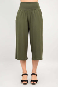 Model standing in olive green bamboo palazzo capri pants, neutral background