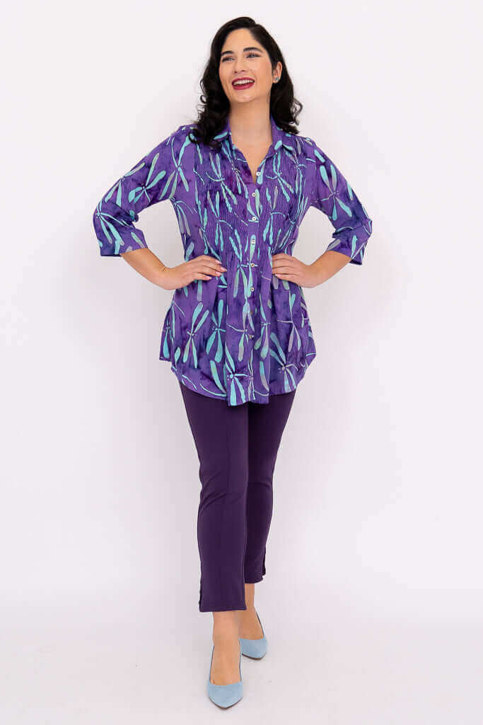 Woman modeling Cindy tunic in dragonfly violet with matching violet pants and light blue heels