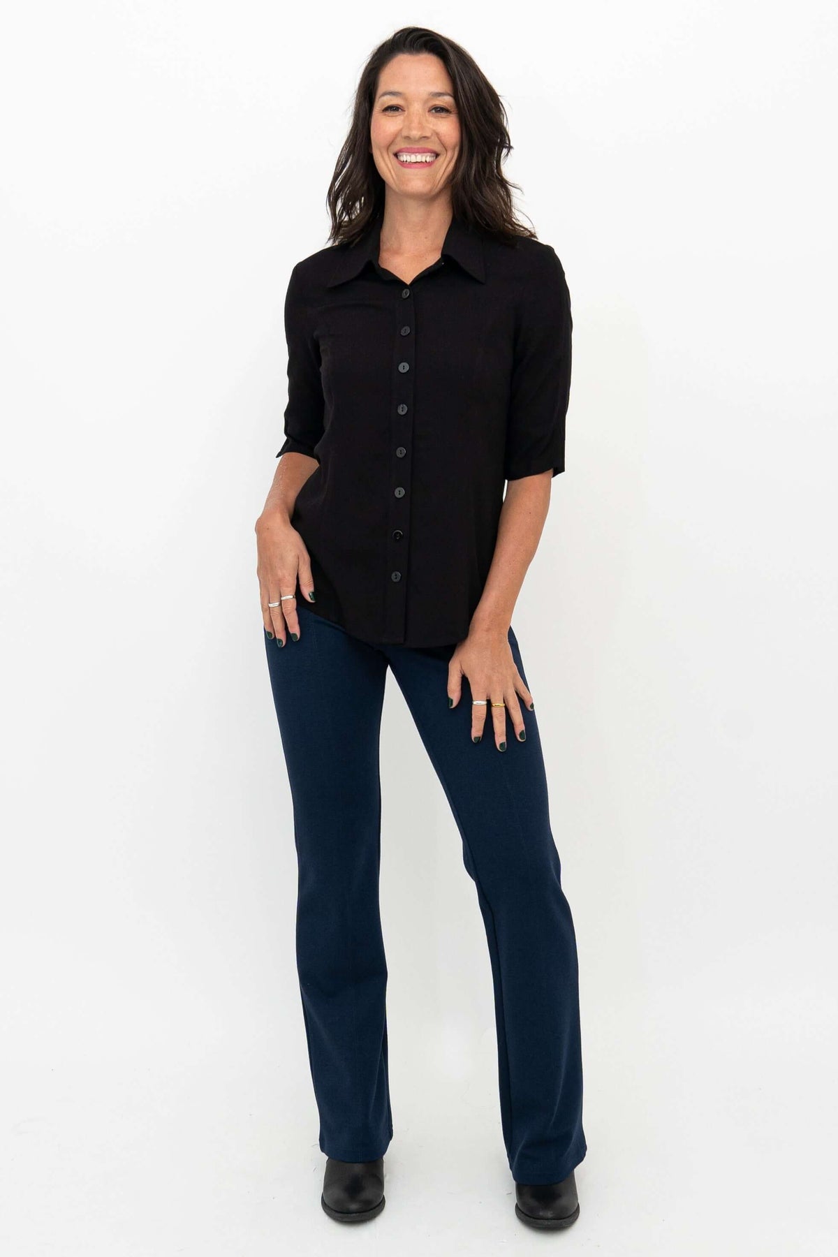 Model wearing Daya modal stretch pants in indigo with a black shirt