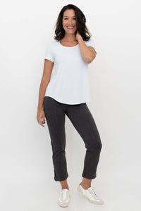 Woman wearing Nadine Crop Pants in charcoal grey with a white top, front view