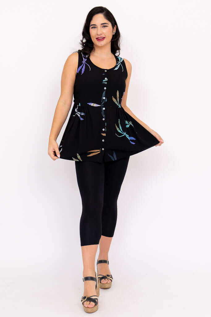 Woman modeling a black sleeveless batik tank with button front, slightly flared hem