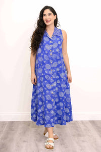 Model with long hair wearing a blue sleeveless dress with swirl patterns and button-up front