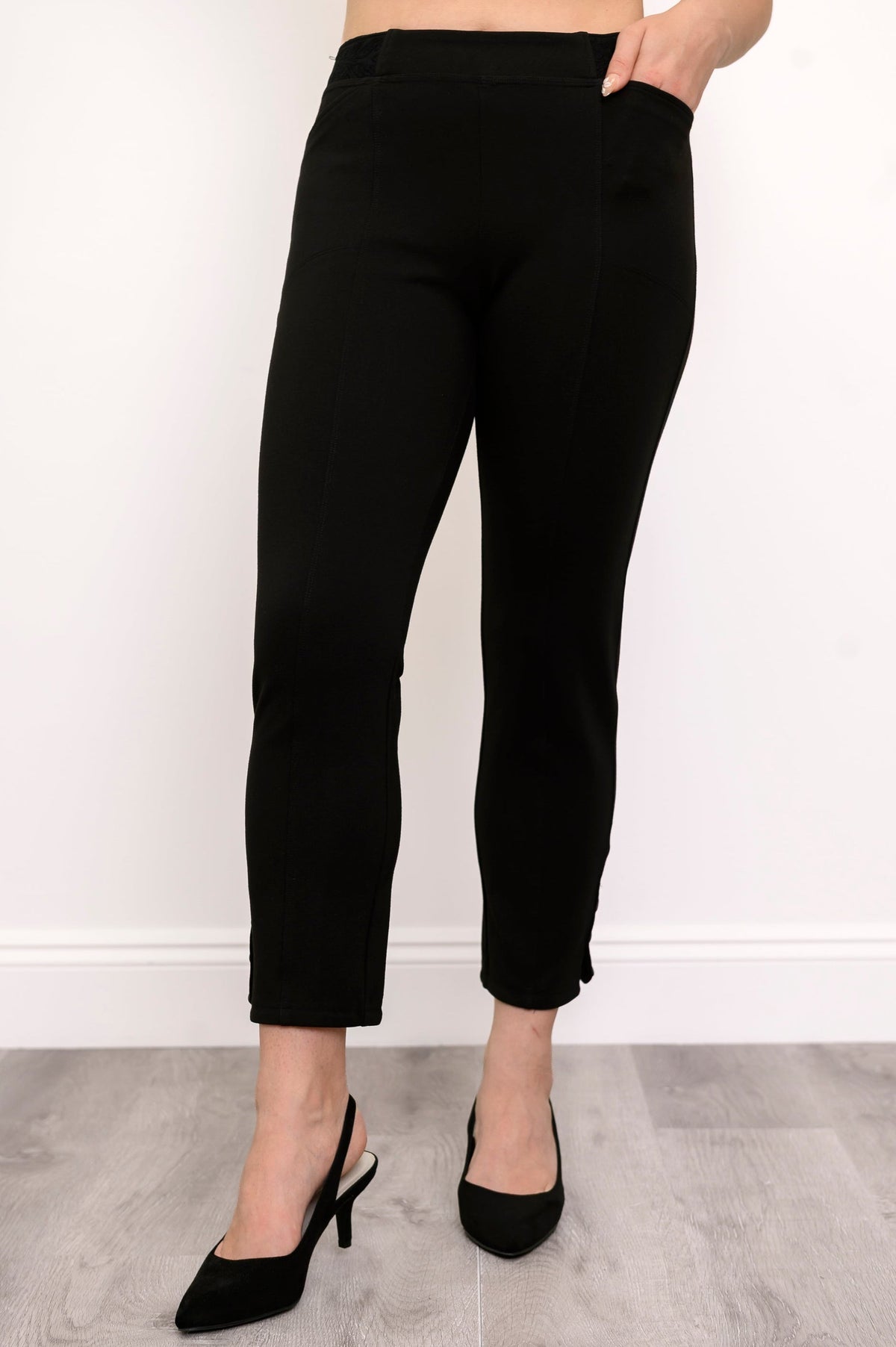 Woman wearing high-rise black cigarette fit pants with pockets