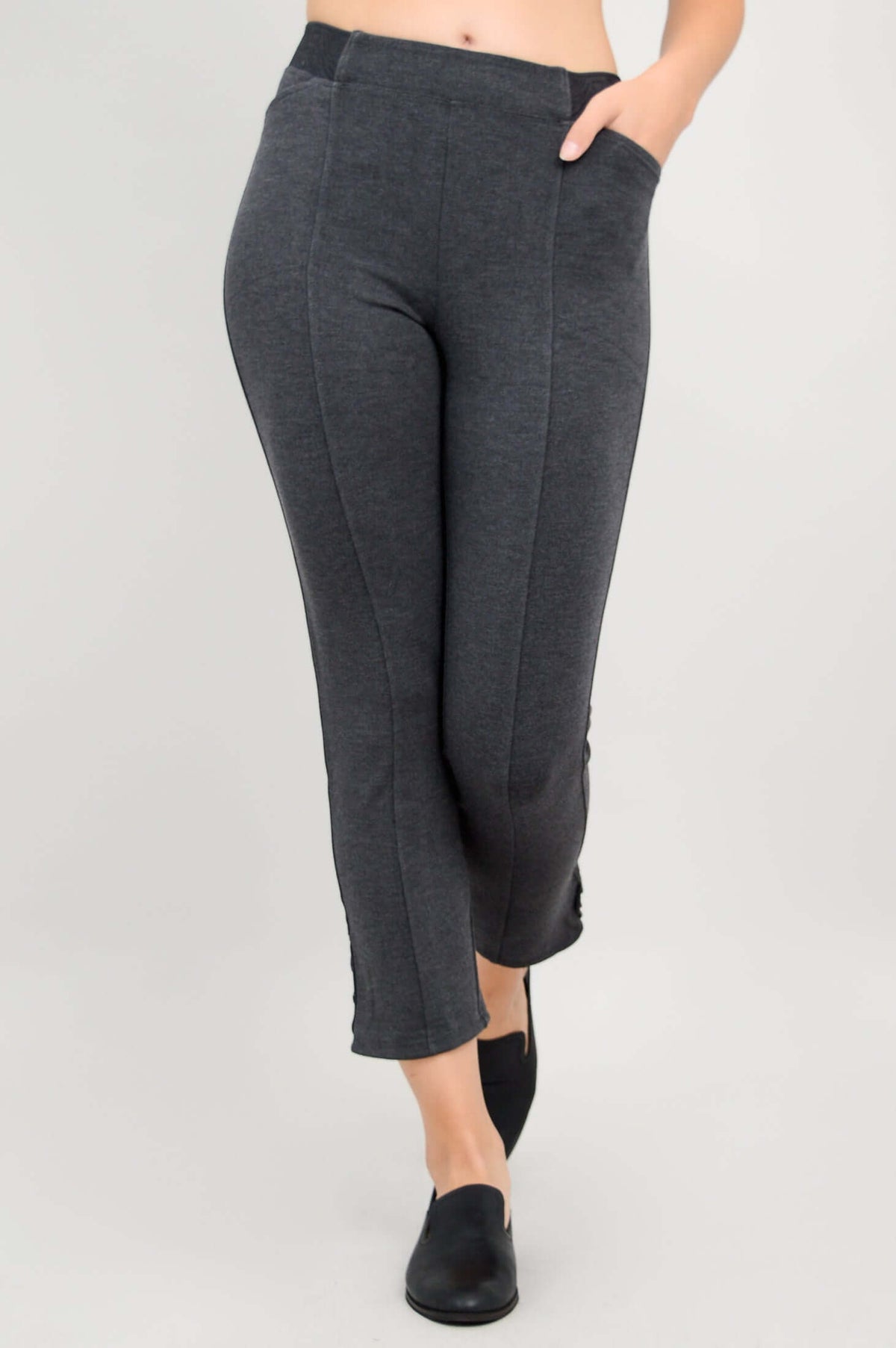 Side angle of Nadine Crop Pants in charcoal grey showing pocket and button detail