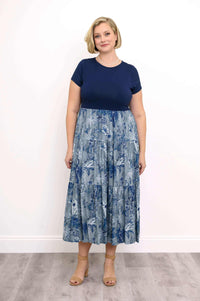 Woman wearing a navy blue and floral patterned midi dress with short sleeves