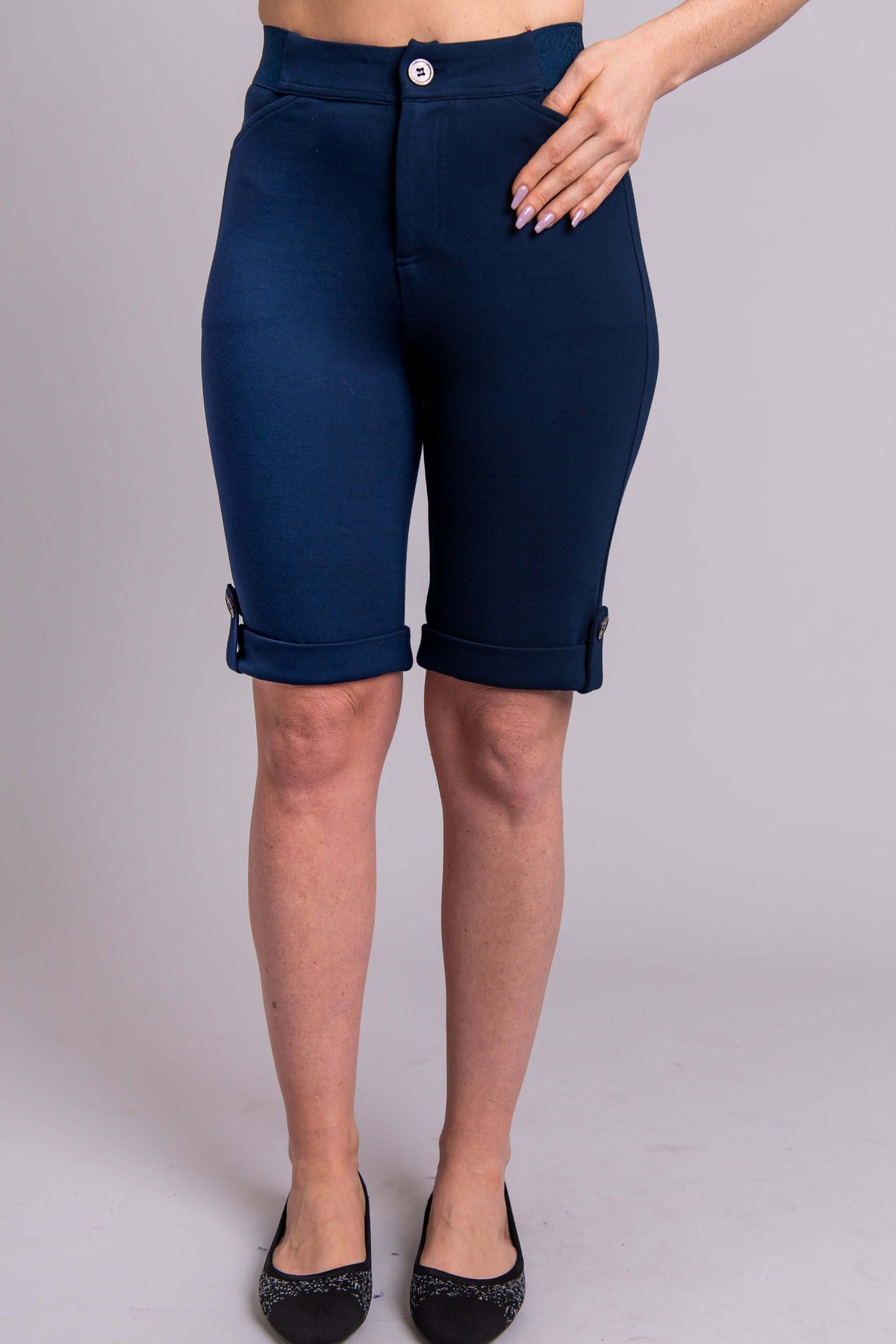 Front view of Norma Short in navy blue with cuffed hems and button closure