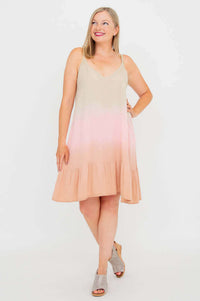 Woman with crossed legs and hand on hip in an ombre sleeveless boho dress