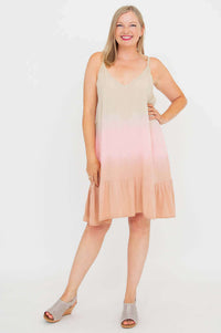Woman posing with one hand on hip in an ombre sleeveless V-neck boho dress