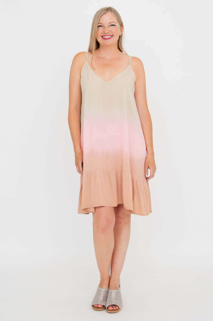 Woman wearing an ombre sleeveless V-neck boho dress with adjustable straps, standing front-facing