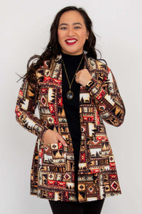 Woman holding lapels of Pauline patterned lightweight jacket, smiling