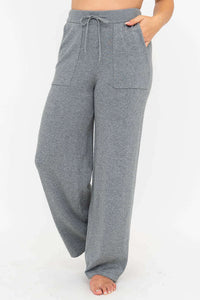 Front view of grey wide leg cotton knit pants with drawstring waist and patch pockets