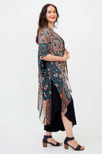 Side profile of model in Darcy kimono wrap with fluid hemline details