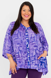 Model wearing a purple patterned V-neck button tunic with 3/4 sleeves