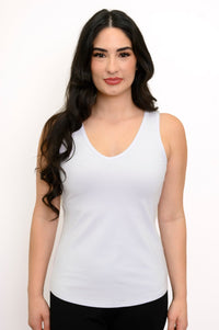 Close up front view of woman wearing v-neck white tank top and smiling