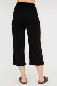 Rear view of black capri pants on model
