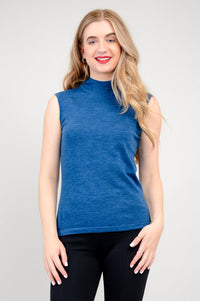 Studio portrait of a model showcasing a vibrant royal blue sleeveless knit pullover top with dark pants.