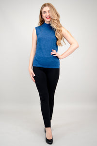 Full length view of a woman wearing an unbuttoned blue cardigan over a matching blue sleeveless mock neck.