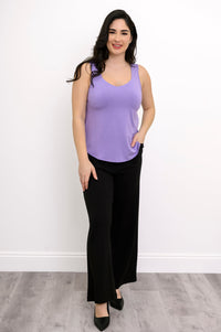 Front view of woman wearing loose-fit lavender tank and black trouser with pockets