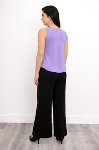 Back view of model in light lilac bamboo tank featuring relaxed fit, styled with black pants