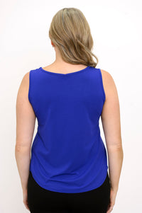 Back view of woman wearing sleeveless navy blue top and navy pants on a white background